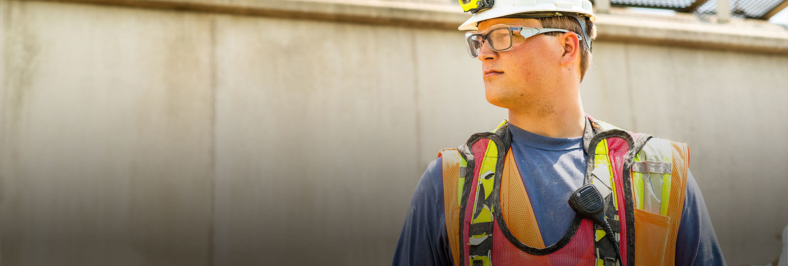 A man in engineers helmet looking sideways
