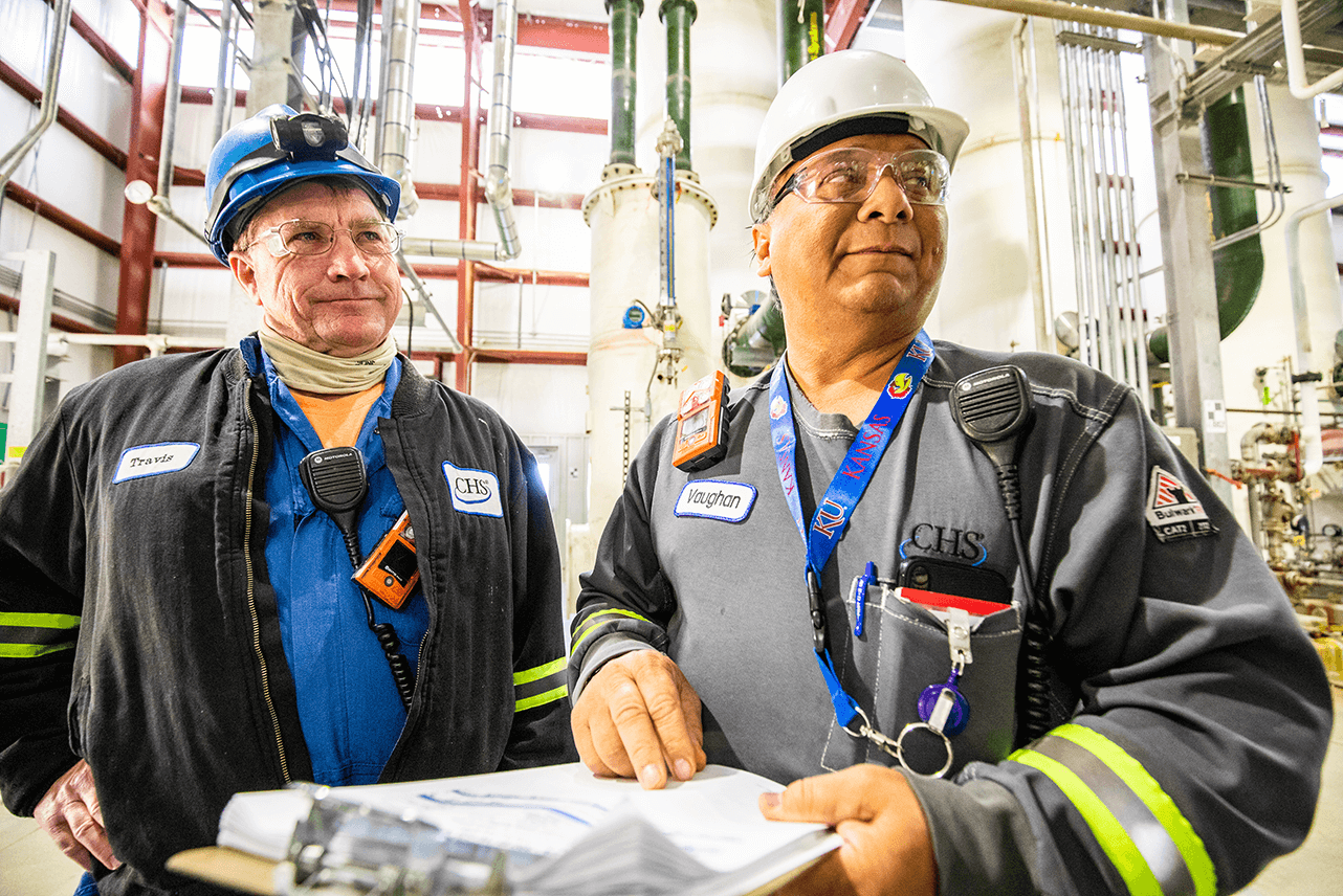 Two employees looking to the right in a company plant
