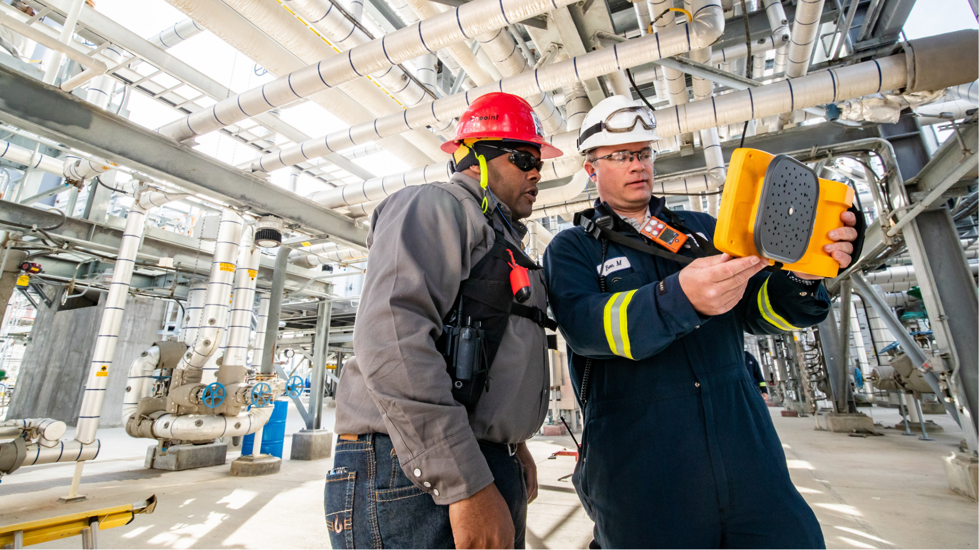 Two employees looking to the right in a company plant.