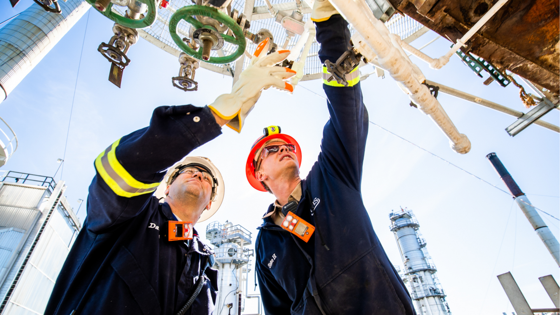 Two employees looking at a valve.