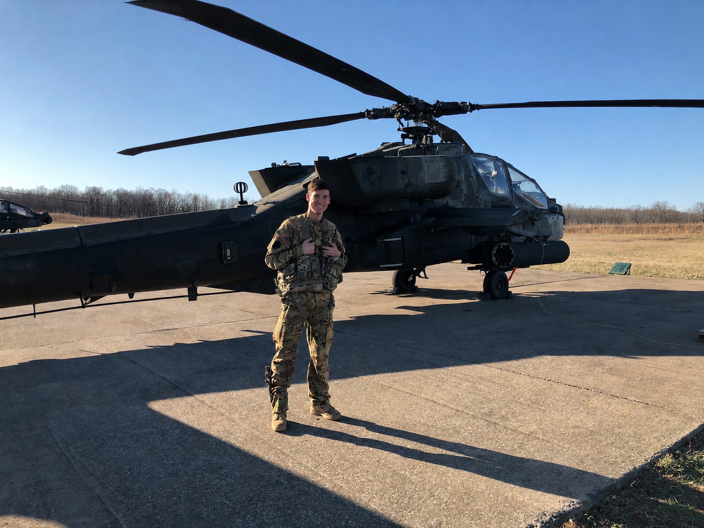 Pilot standing next to a helicopter.