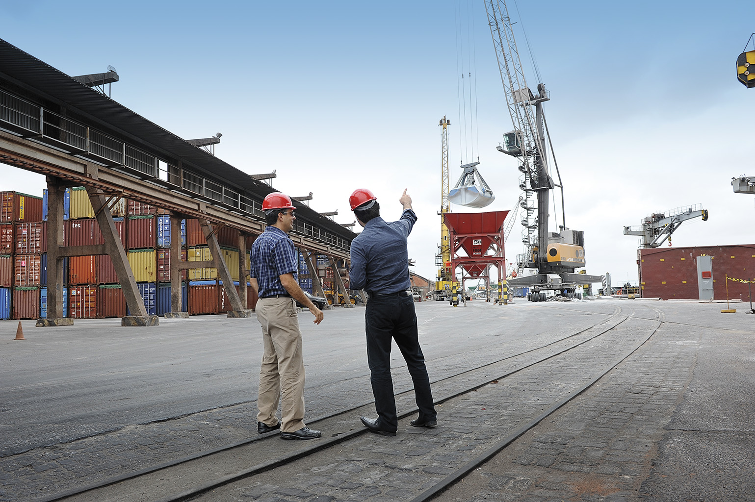 Two men watching a crane