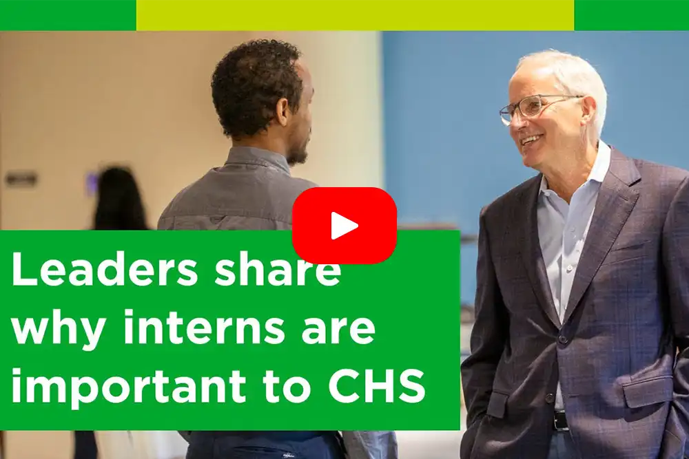Two men in business attire talking, with an overlay text that reads: 'Leaders share why interns are important to CHS'