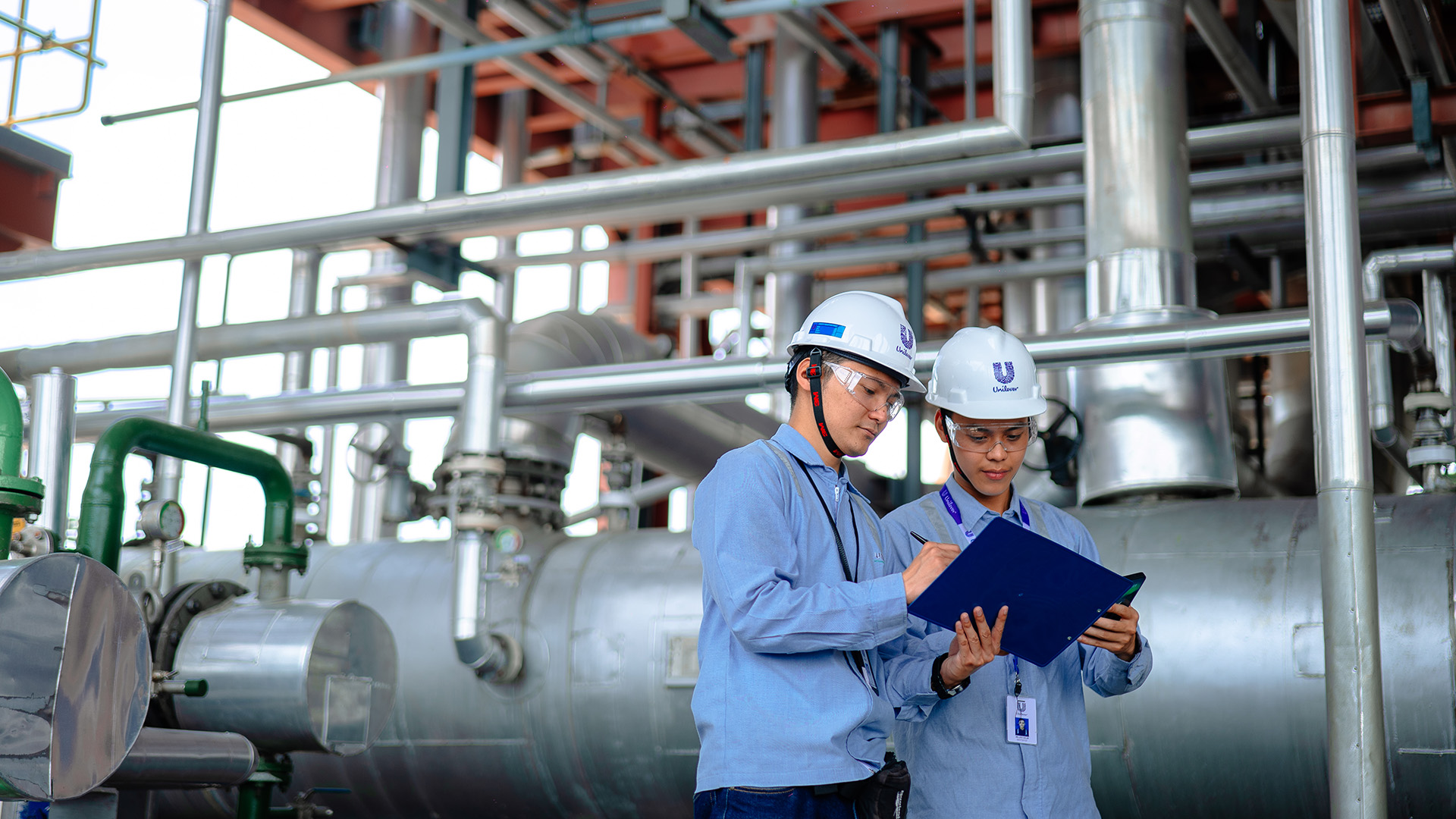 Two Unilever employees checking a document