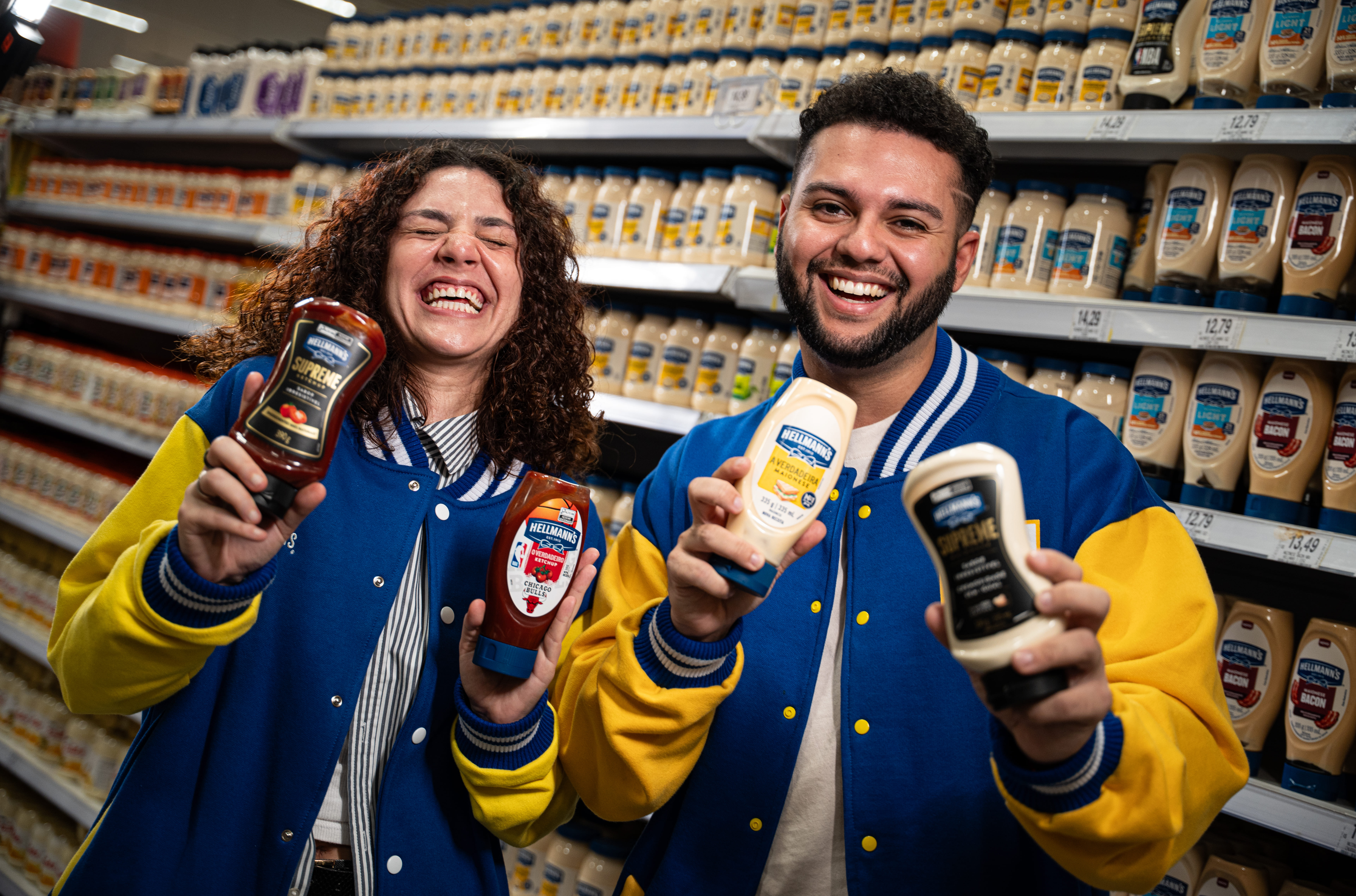 Two people in conversation at a table in a modern office environment.