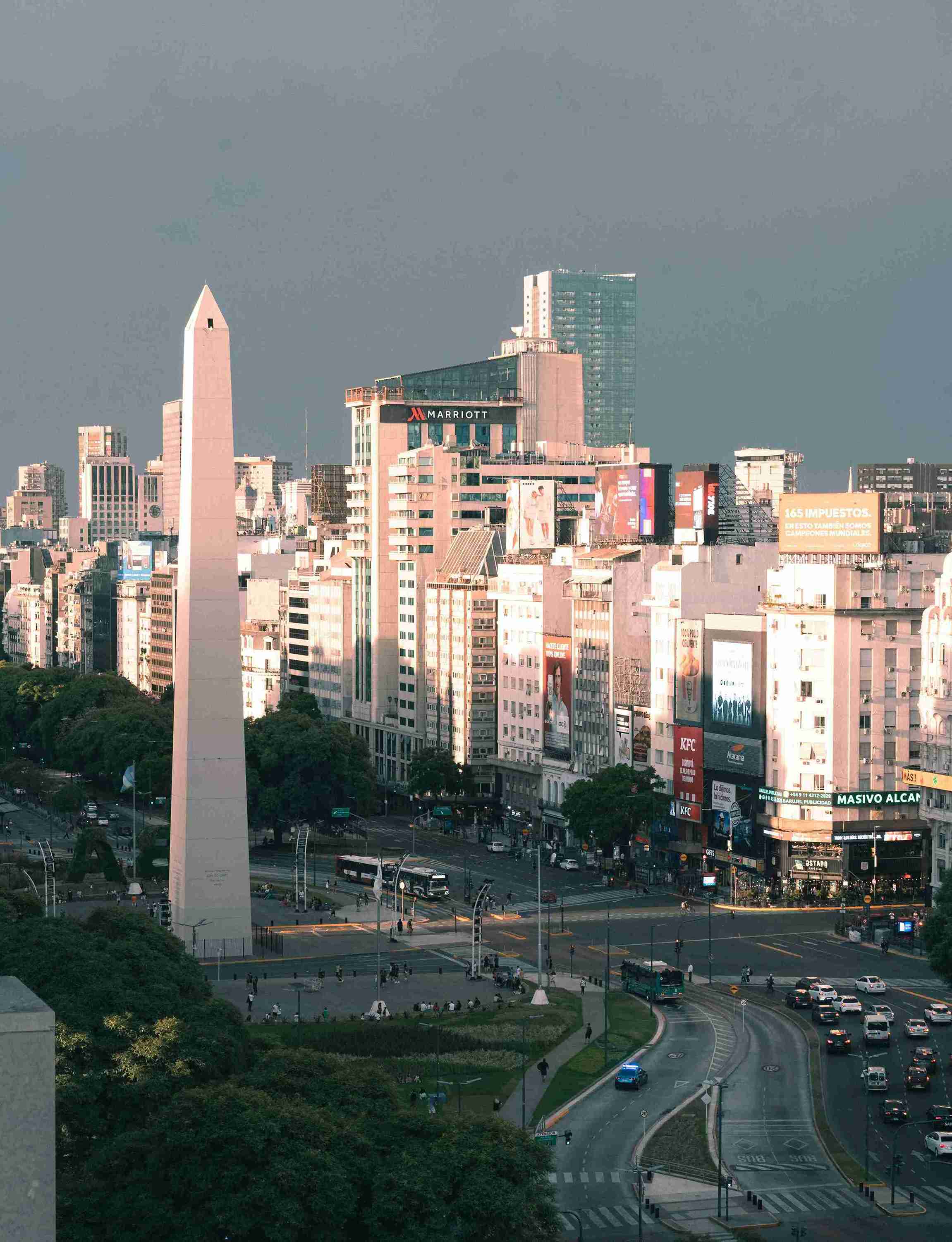 City skyline with tall obelisk and busy streets