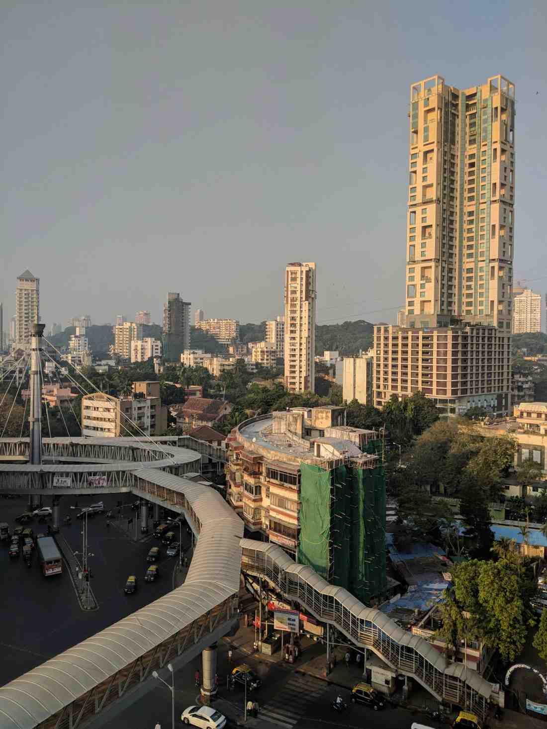 City skyline with tall towers and curved skywalk road