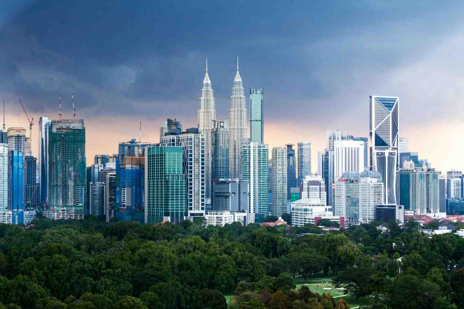 Kuala Lumpur skyline with Petronas Towers and city buildings.