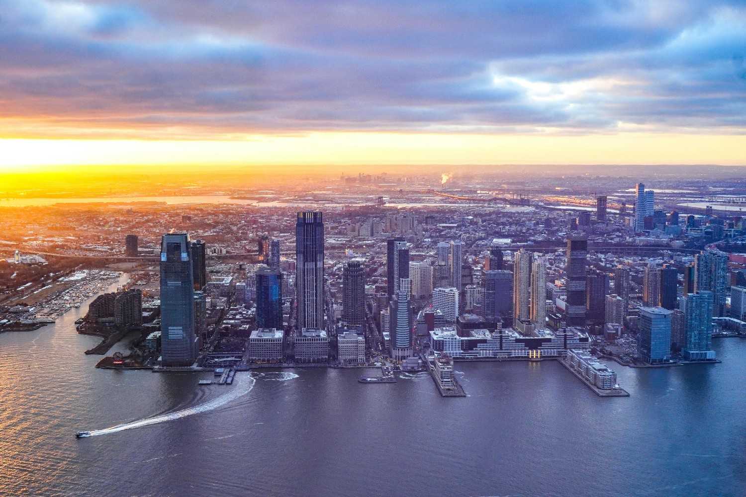 Aerial city view at sunrise with tall riverside towers