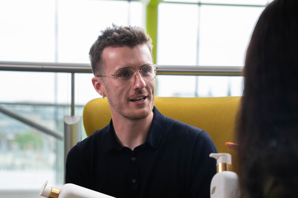 Two colleagues talking in a bright office space.