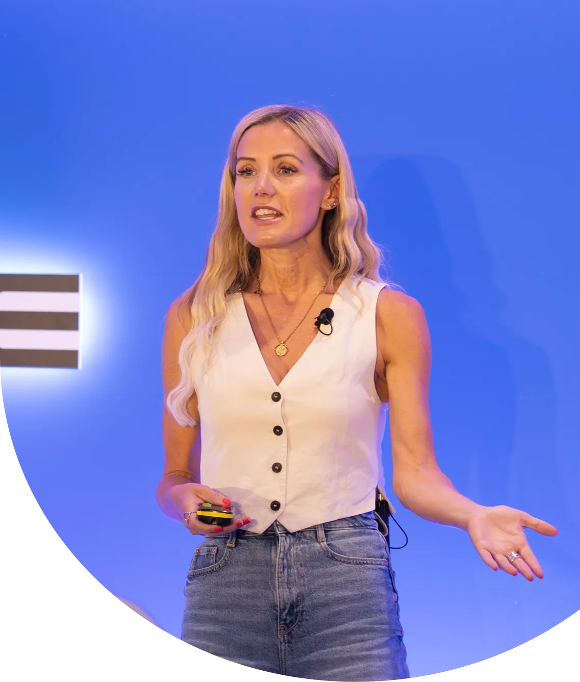 Professional giving a talk on a stage before a blue background