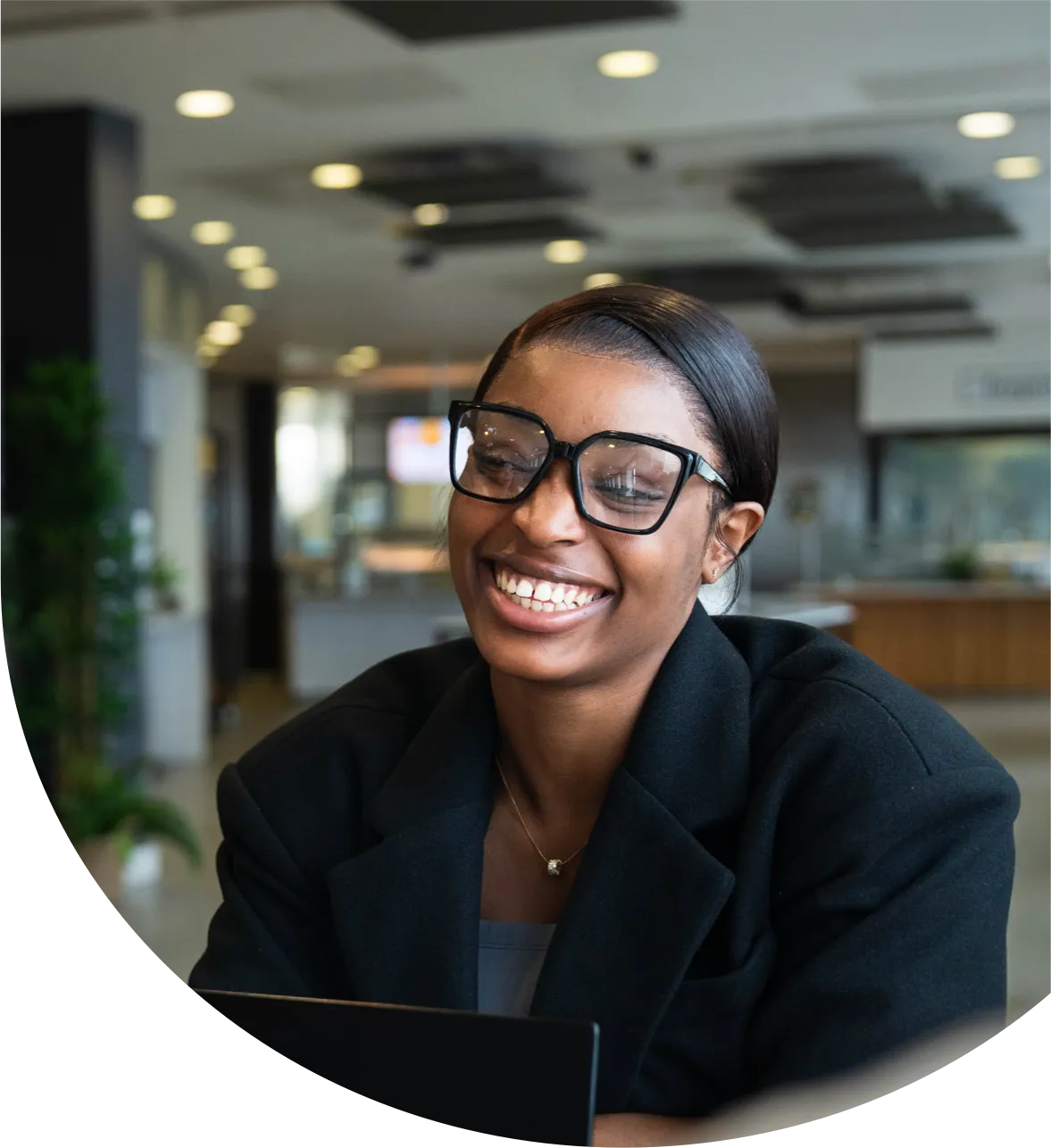 Smiling employee in a large modern office