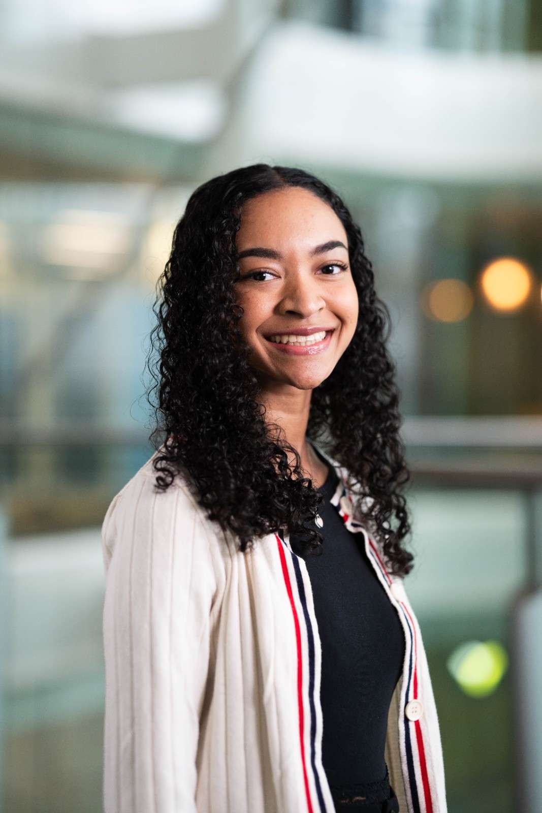 Smiling woman posing indoors in a modern office