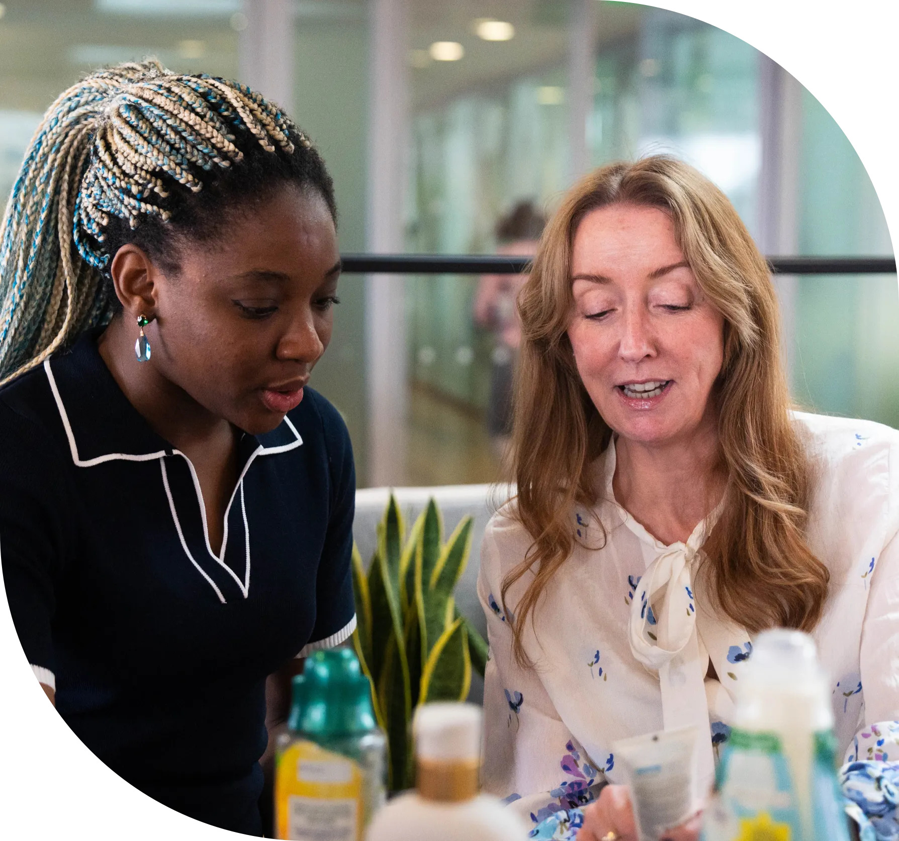 Two women discussing product packaging at a table