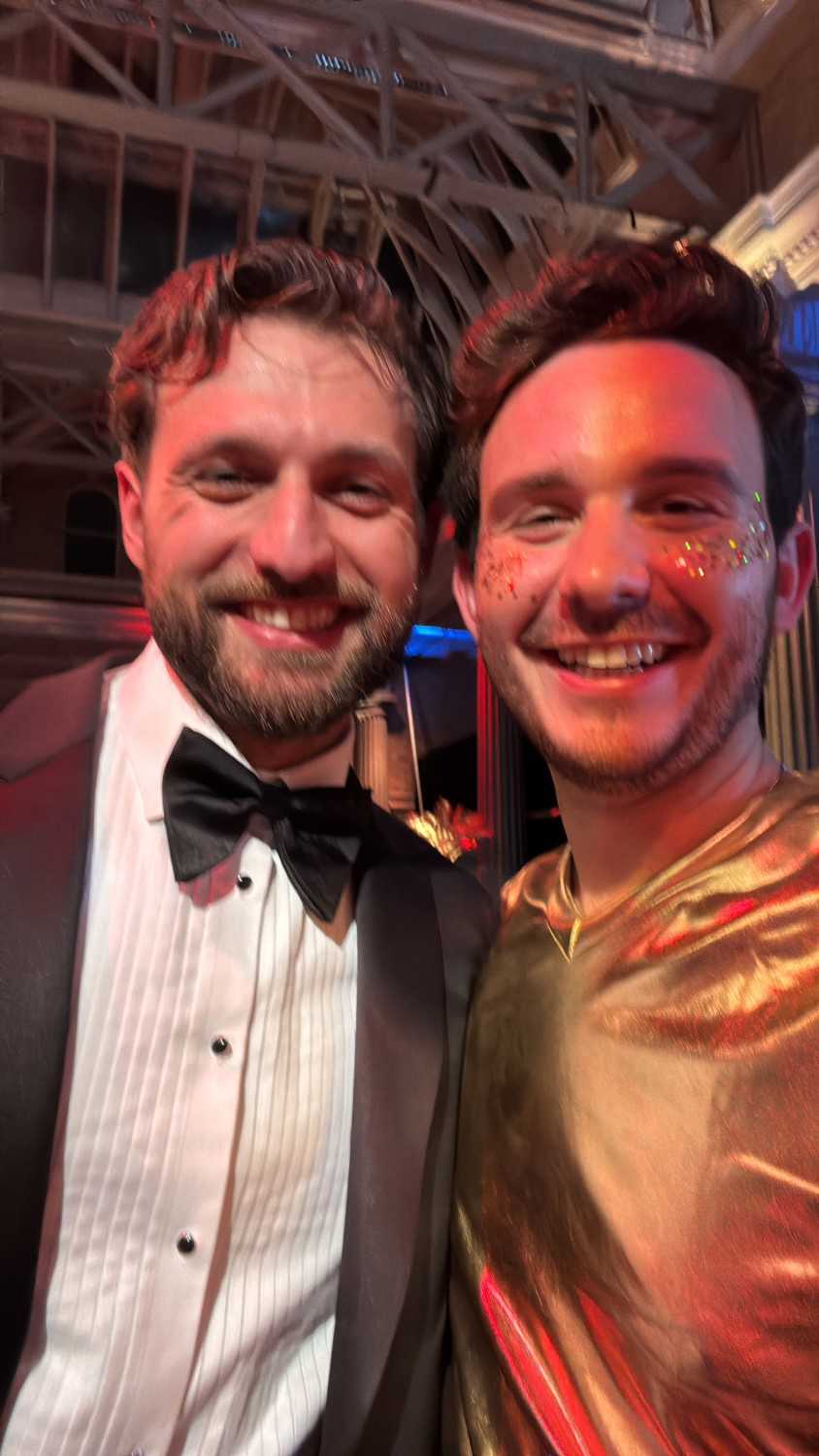 Two Unilever colleagues in formal dress smiling at a black-tie awards evening.