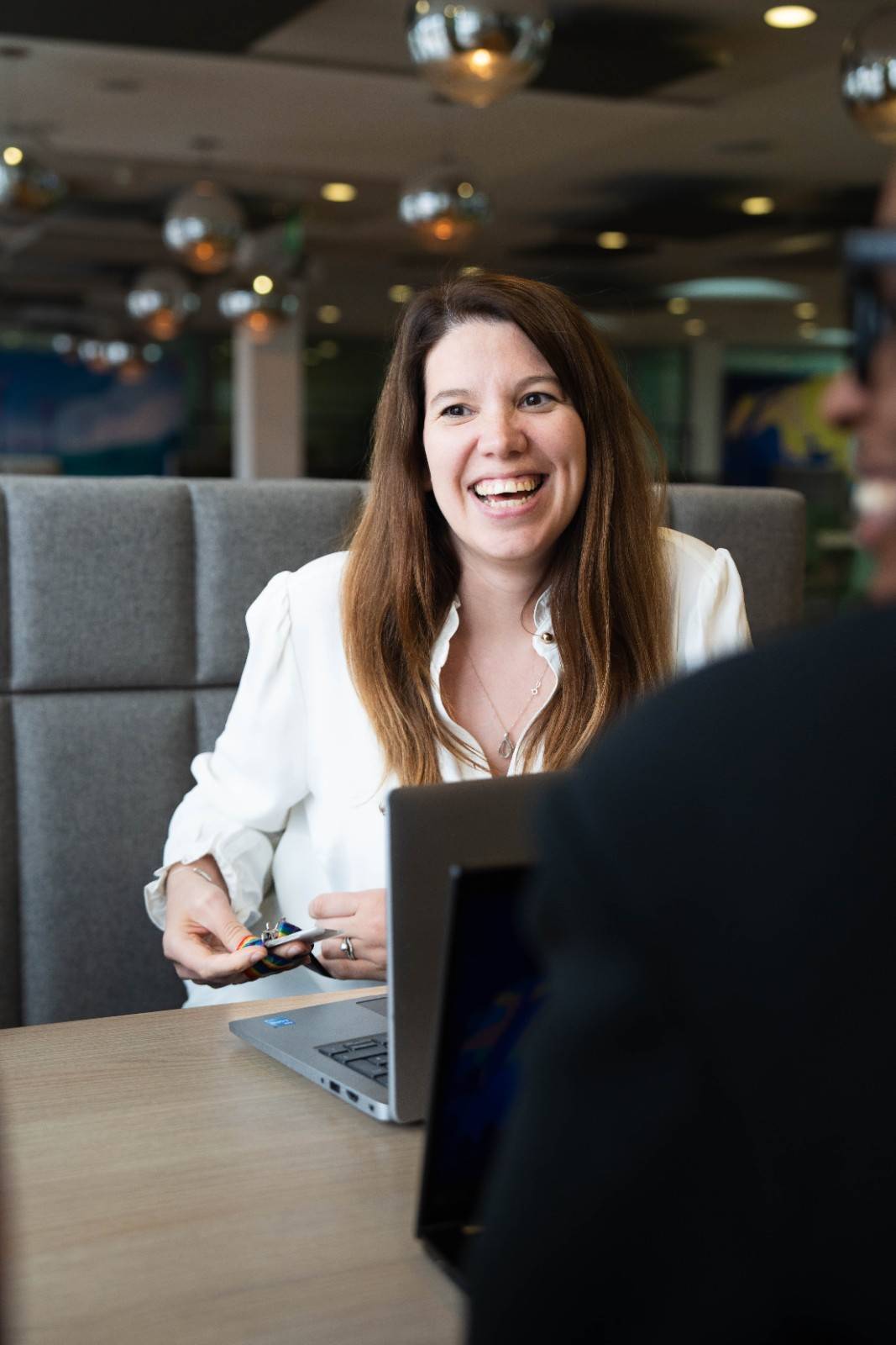 Smiling woman talking during an office meeting.