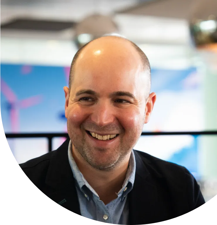 Smiling employee in a large indoor space