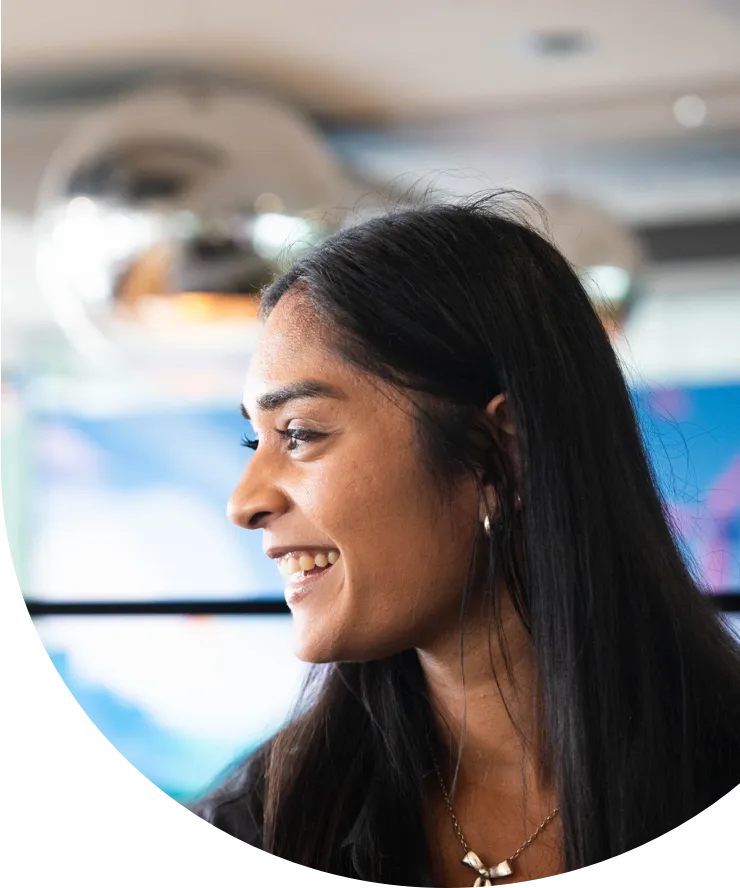 Smiling employee in a large modern office