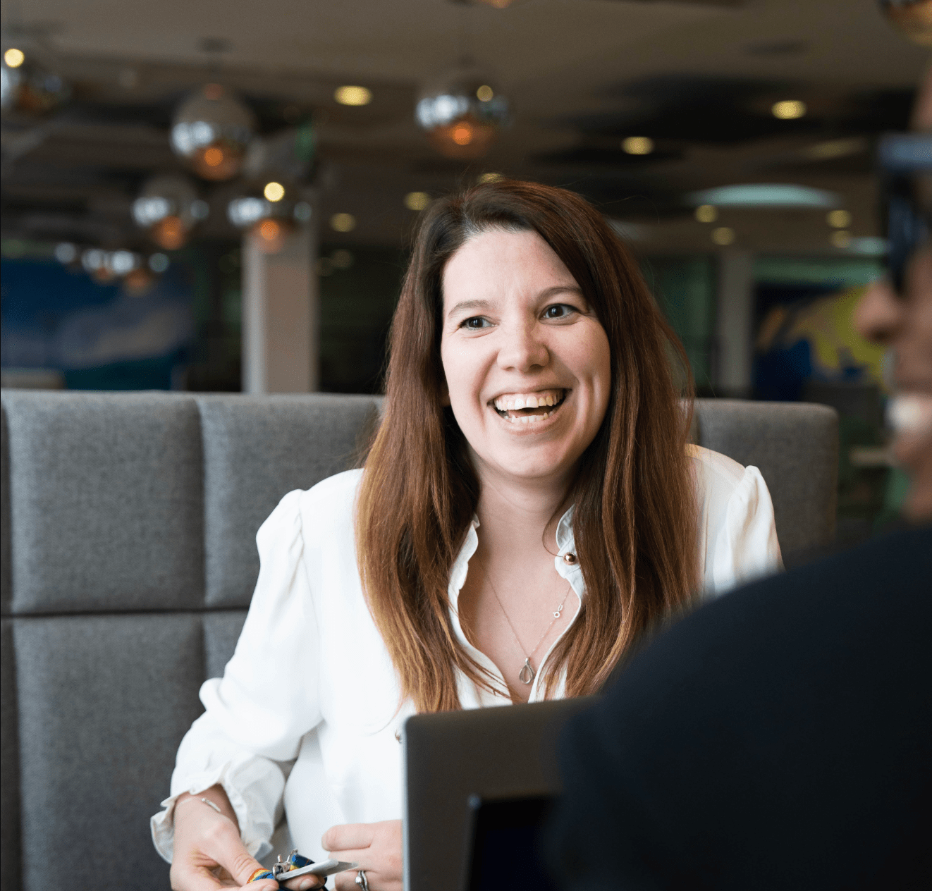 Smiling woman talking during an office meeting.