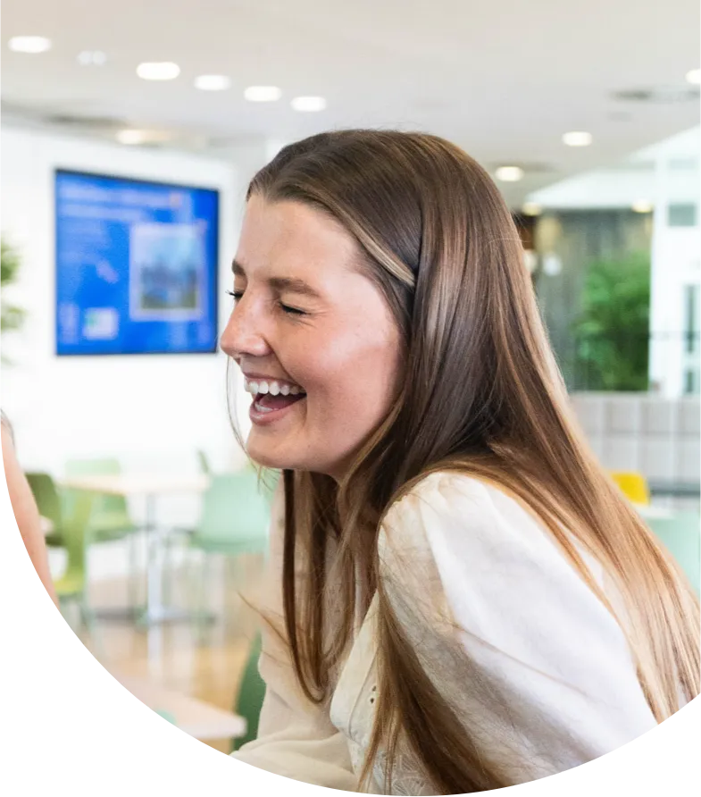 Smiling employee in a large modern office