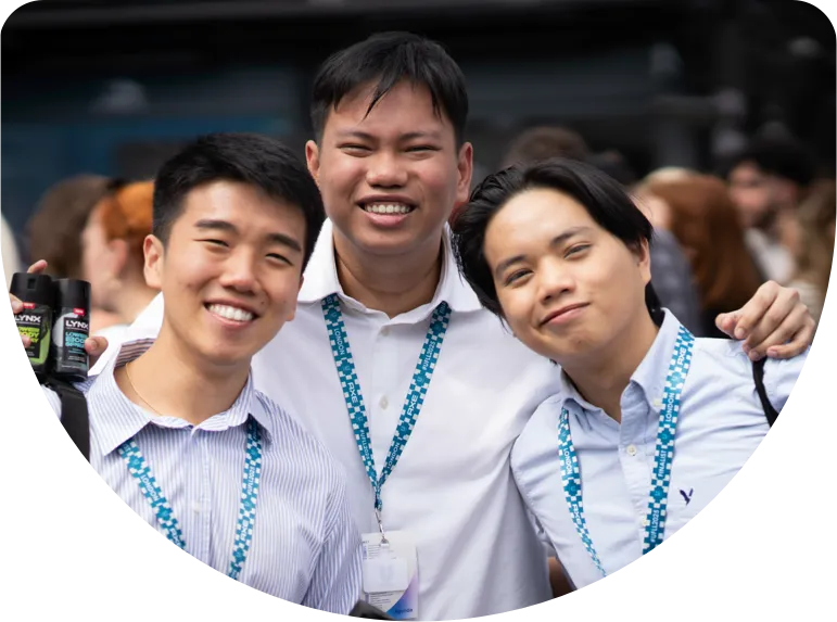 young professionals posing and smiling at a conference