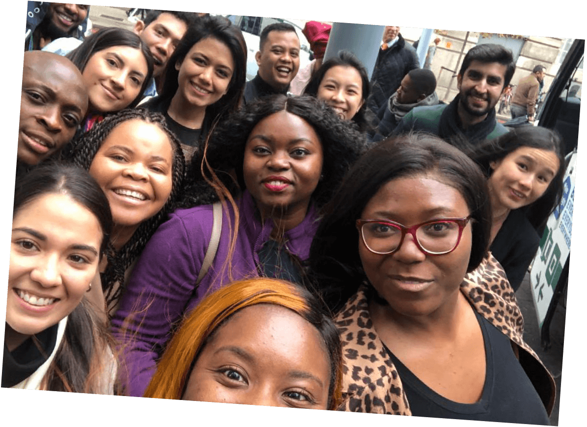 A group of employees pose for a selfie outside