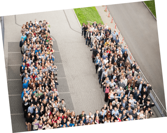 A large group of employees stand in the shape of the Unilever 'U' logo