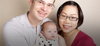 Image of a young family including father, mother and baby.