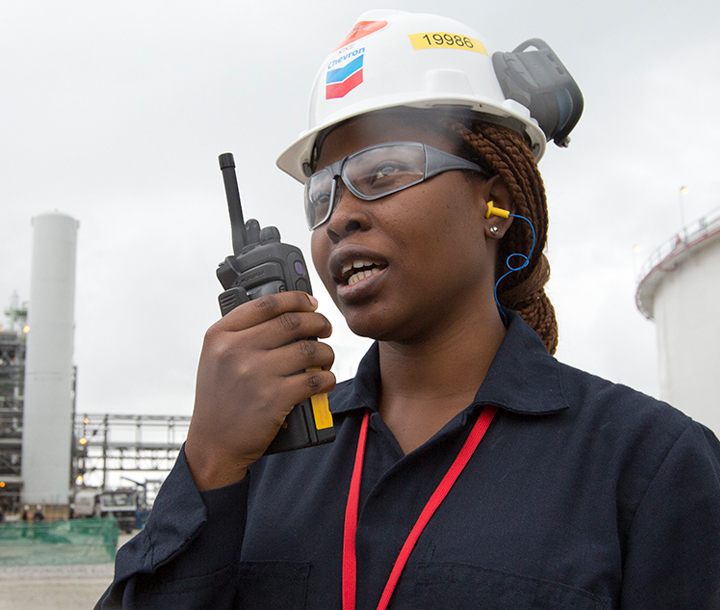 Chevron employee speaking into walkie-talkie