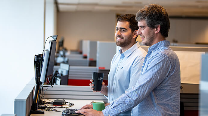 Two men looking at the computer screen