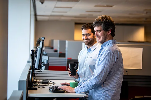 Two men looking at the computer screen