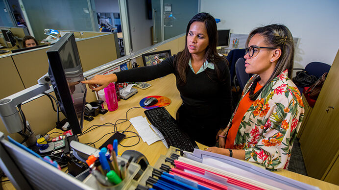 two women employees discussing