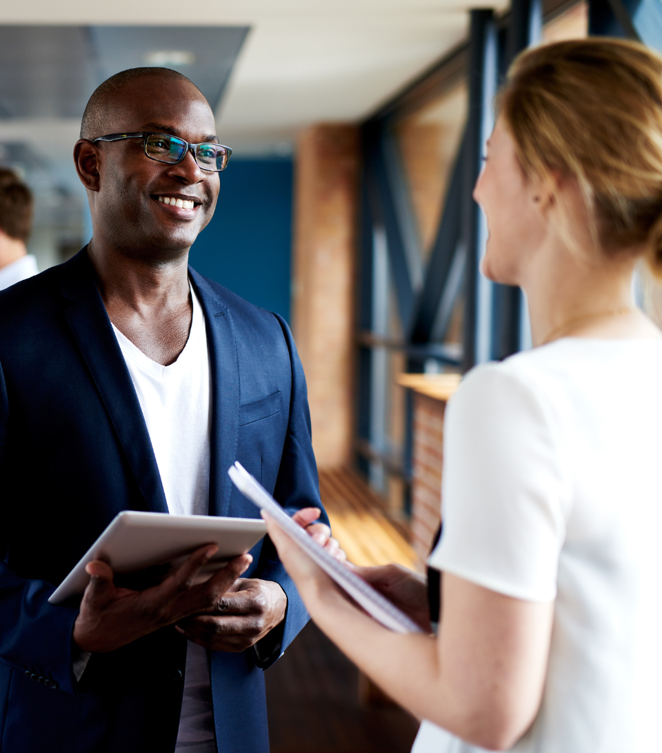 Two executive professionals engaged in conversation