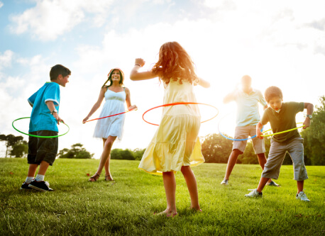 group of people playing with hula hoops in a field