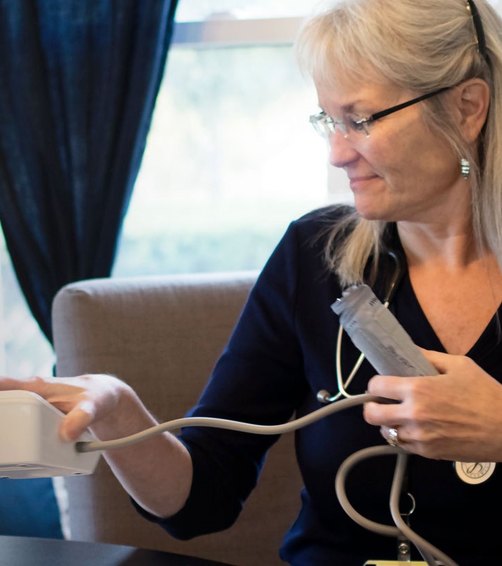Woman using a blood pressure cuff