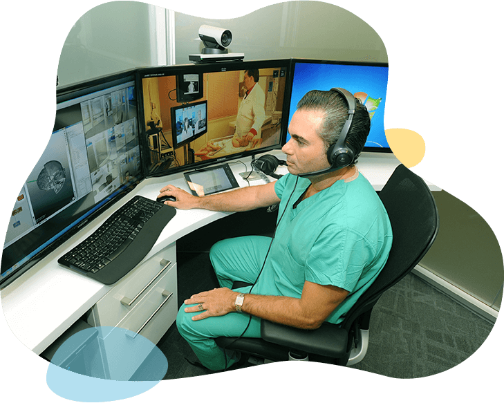 Man with headset sitting infront of computer screens