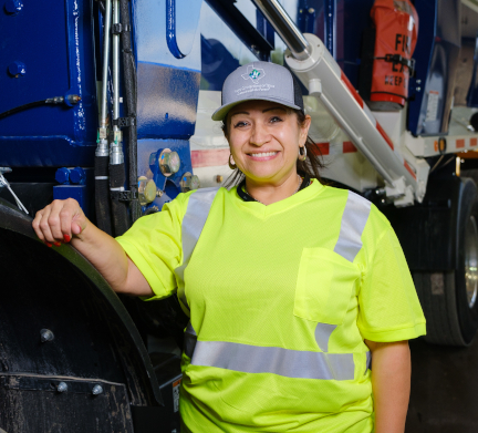 Woman standing in front of Waste Connections truck