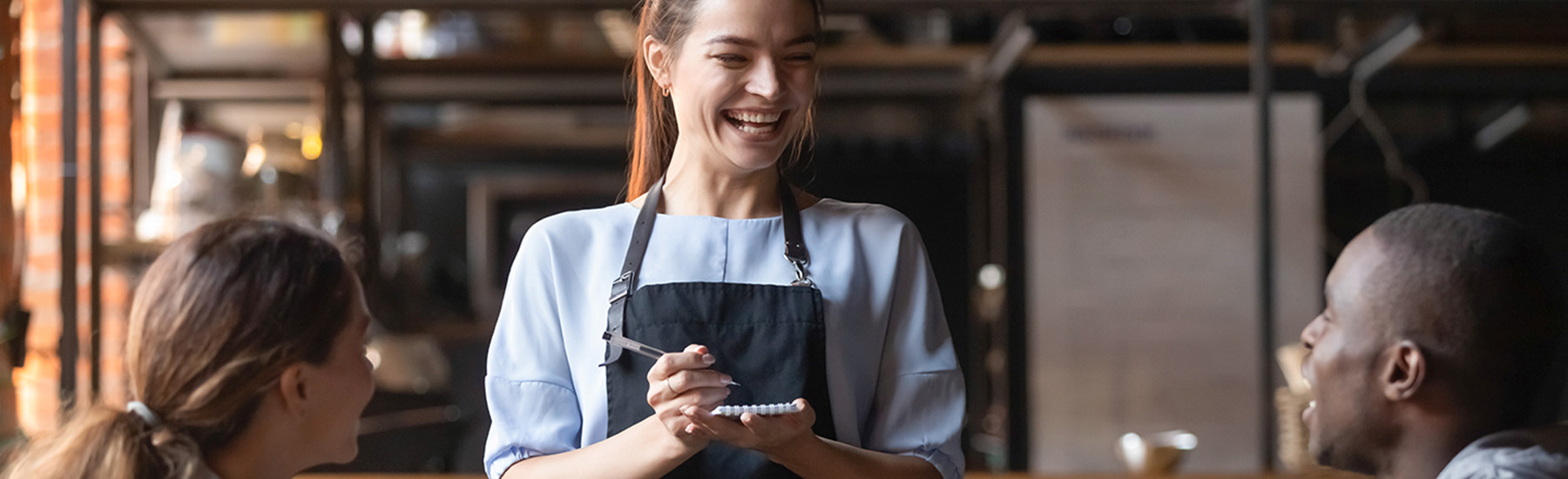 Woman waitress taking order of two people