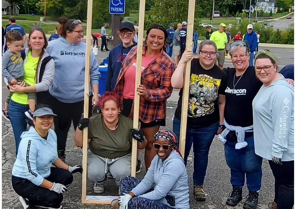 Smiling volunteers posing during a community service project.