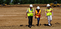 Three people talking on a job site