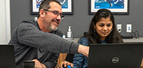 Man pointing at a laptop