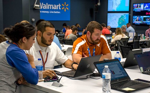 Lots of people with laptops at walmart conference