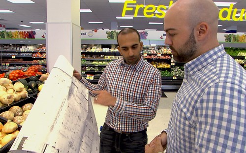 two people looking at blueprints in store
