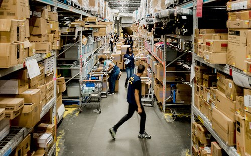 people walking and working at warehouse