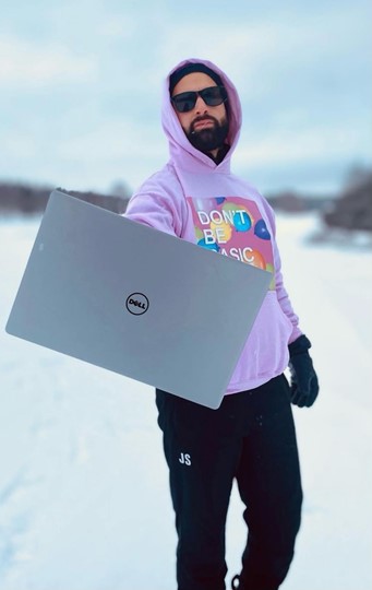 Jonny holding a Dell laptop