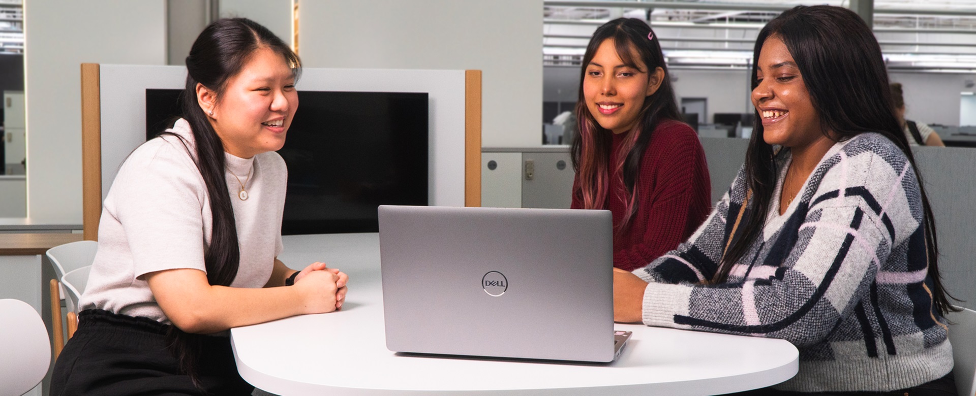 three employees sitting at a table 