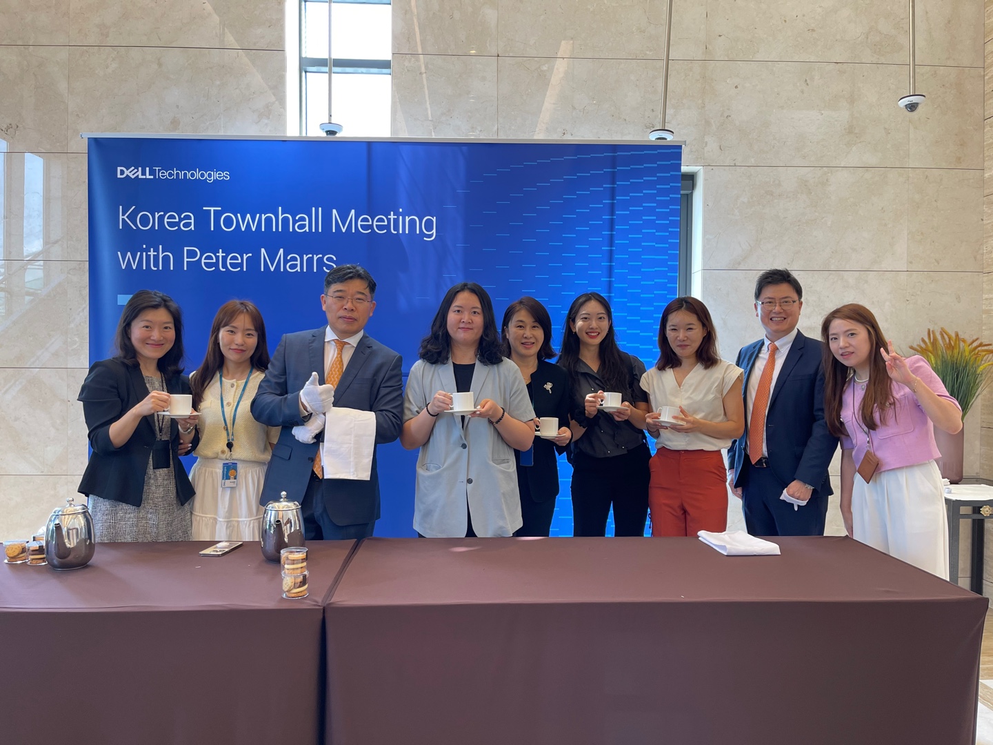 Jin Kyung takes a picture with co-workers at the Korean Townhall meeting