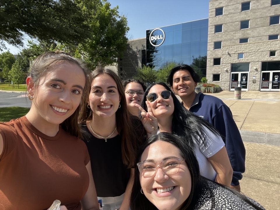 Athena poses outside of a Dell building with five other people.