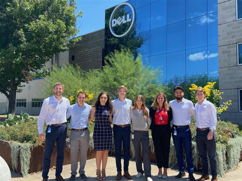 Anna poses outside of a Dell building with other employees.