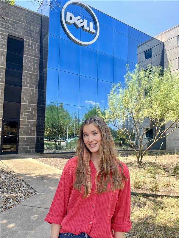 Anna poses in front of a Dell building.